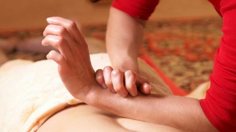 Woman providing a professional Thai massage