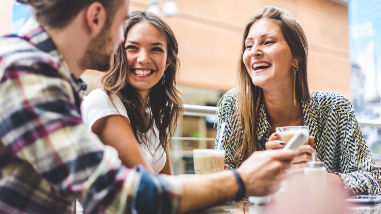 Three people socialising over drinks