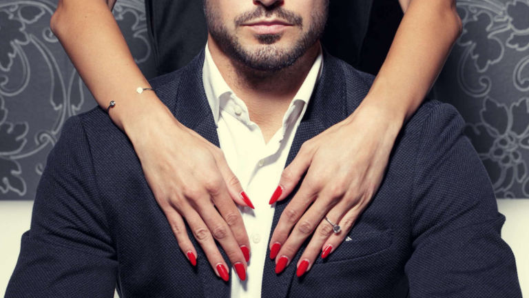 Woman with red nails embracing rich sugar daddy from behind
