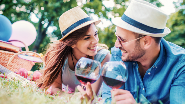 Man and woman on first date enjoying a picnic in the park