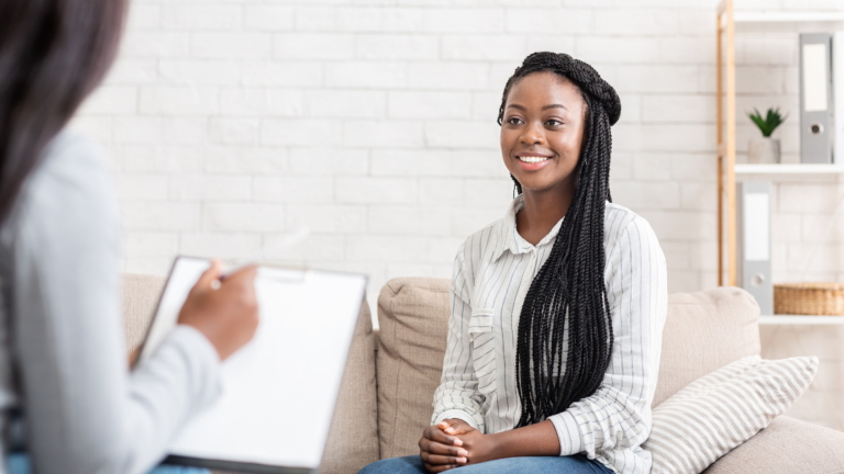 Woman sitting with psychologist in office having a successful therapy session