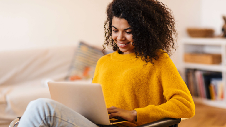 Woman sitting in living room on laptop