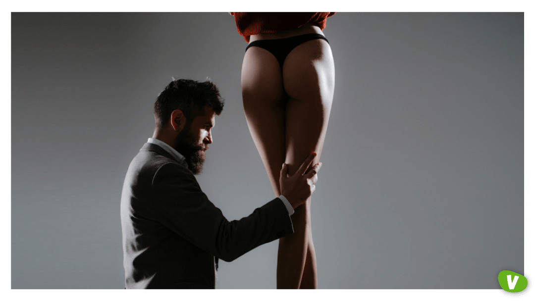 man kneeling by a woman in panties