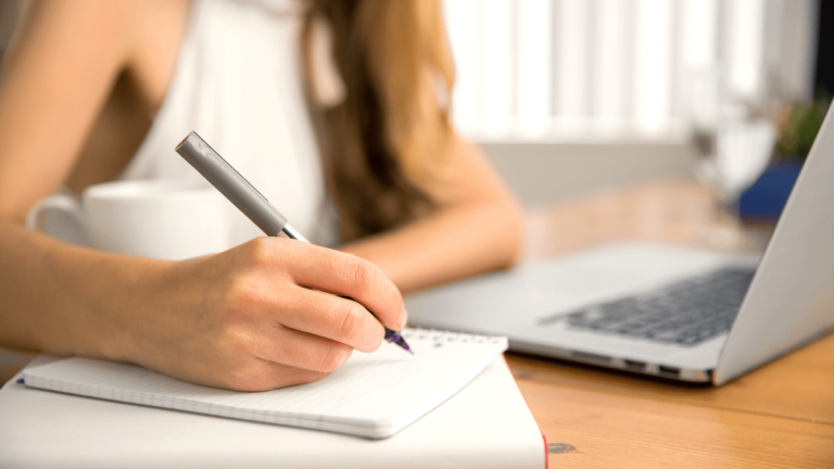woman writing in a notepad