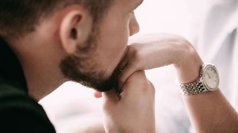 Bearded man kisses woman's hand