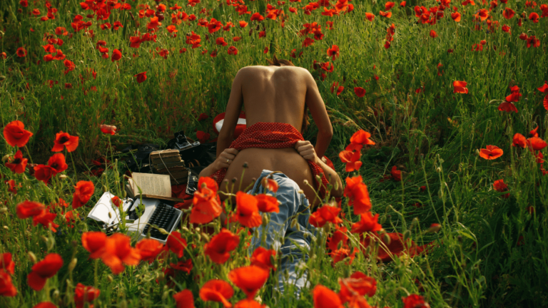 young adult couple lying on the grass over sunset having sex