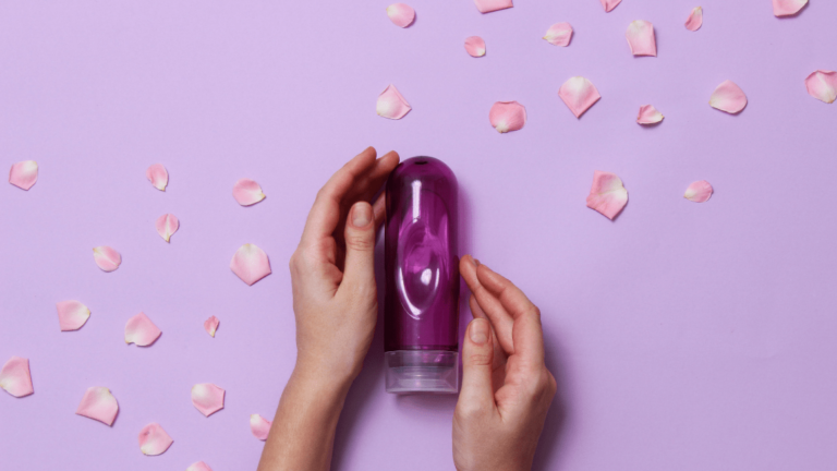 sexual lubricant on a pastel background in female hands and rose petals
