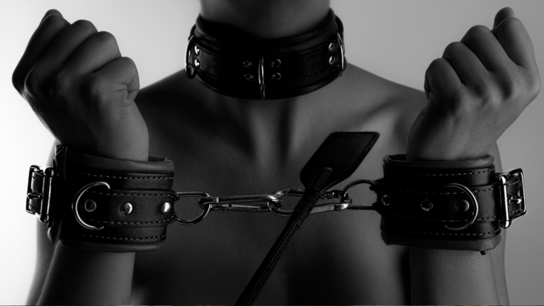 BDSM girl with collar chains and flogger