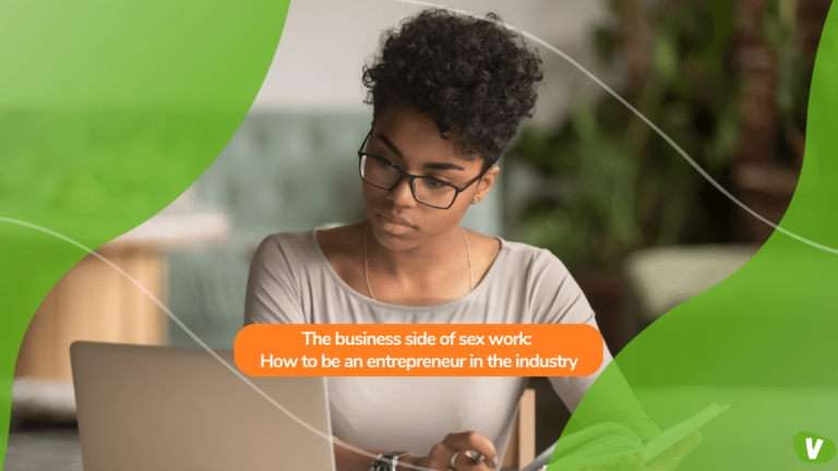 focused young african american businesswoman looking at a laptop while holding a book