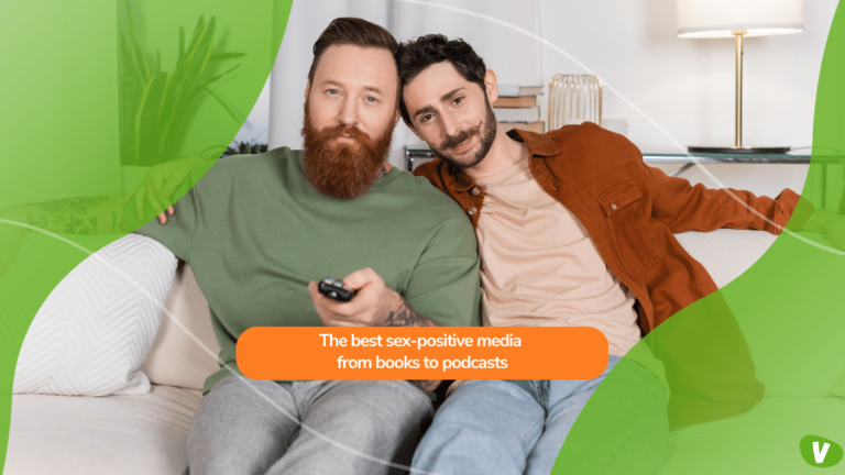 bearded same sex couple watching tv on couch at home