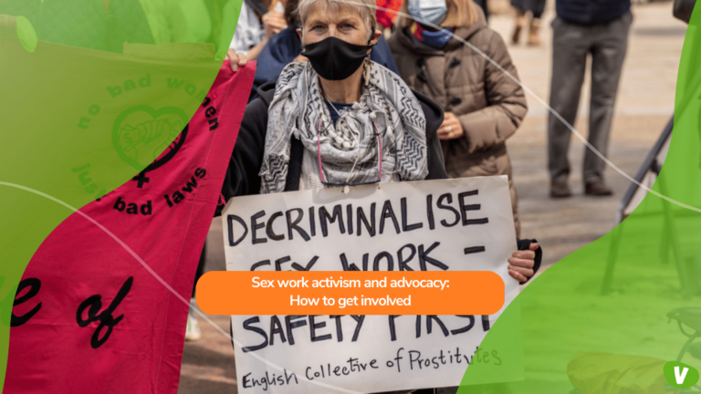 A woman holds a sign saying decriminalize sex work during a crowded protest and march at The Mall, City of Westminster