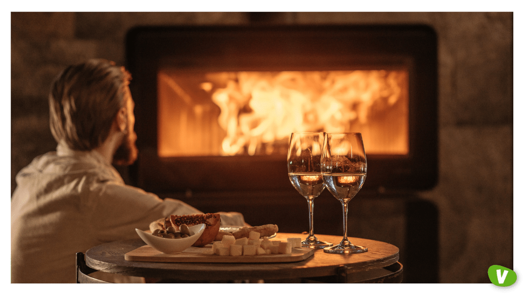 man sitting by a fireplace