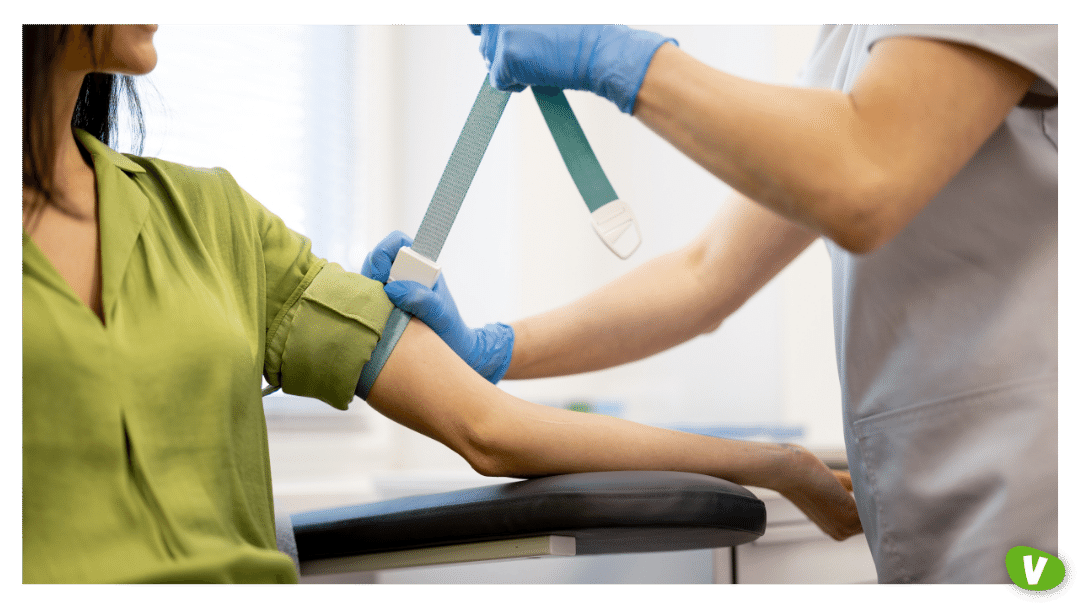 a nurse checking woman's blood pressure