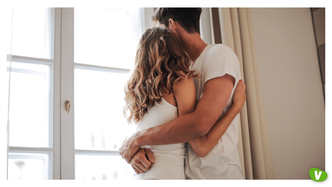 couple in embrace looking out the window