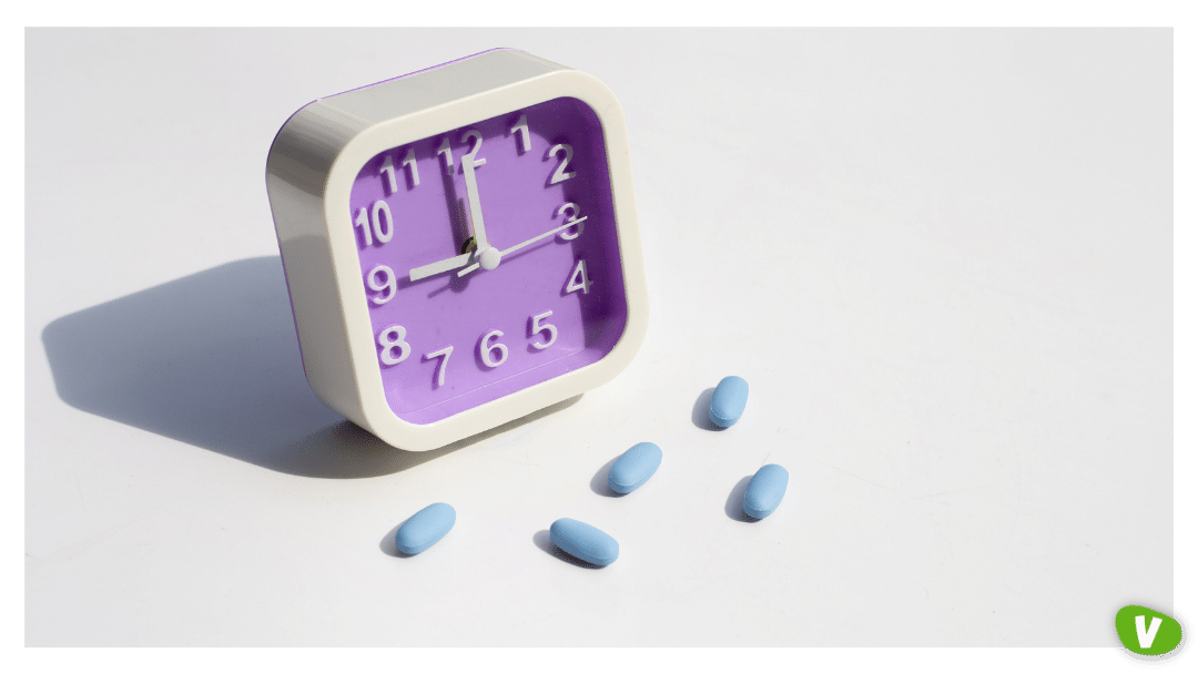 a clock with blue pills on a white background