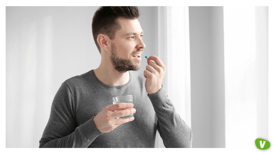 a man taking pre-exposure prophylaxis with a glass of water