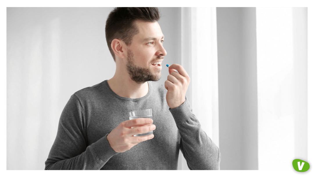 a man taking pre-exposure prophylaxis with a glass of water