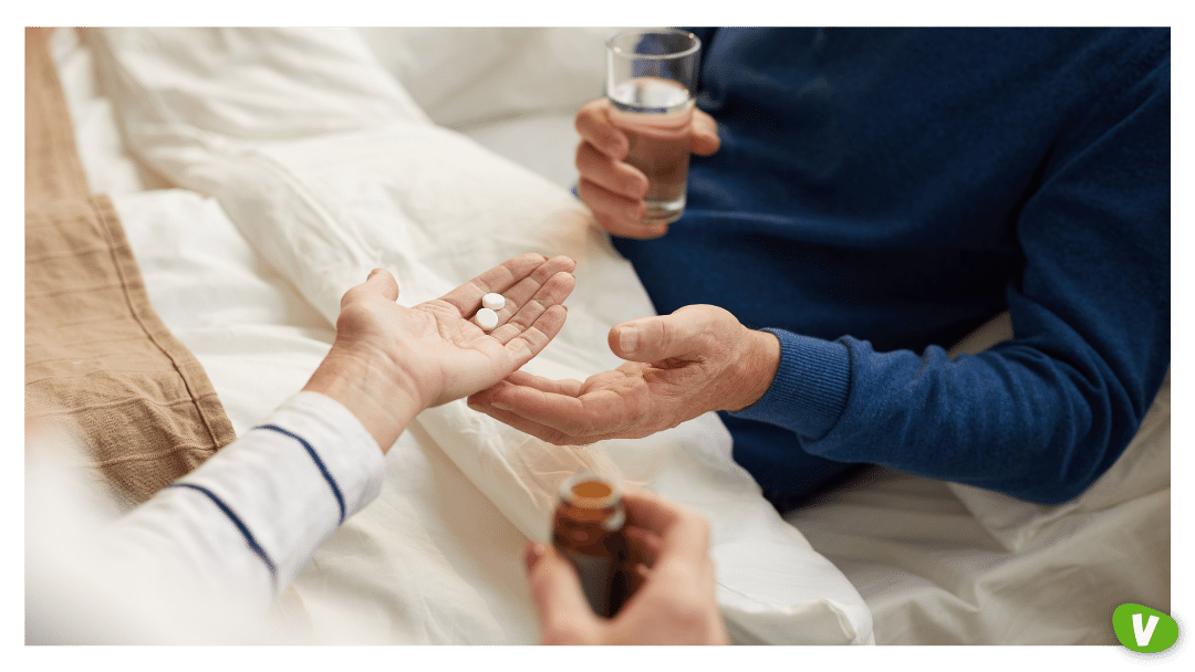 close up of a man taking pills from his wife