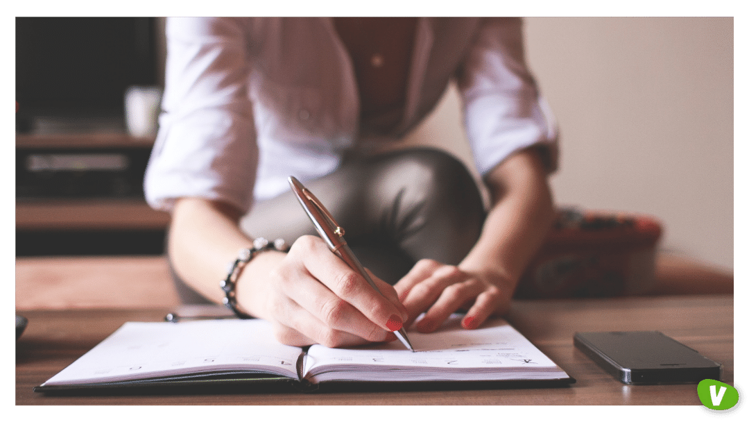 woman writing in a planner