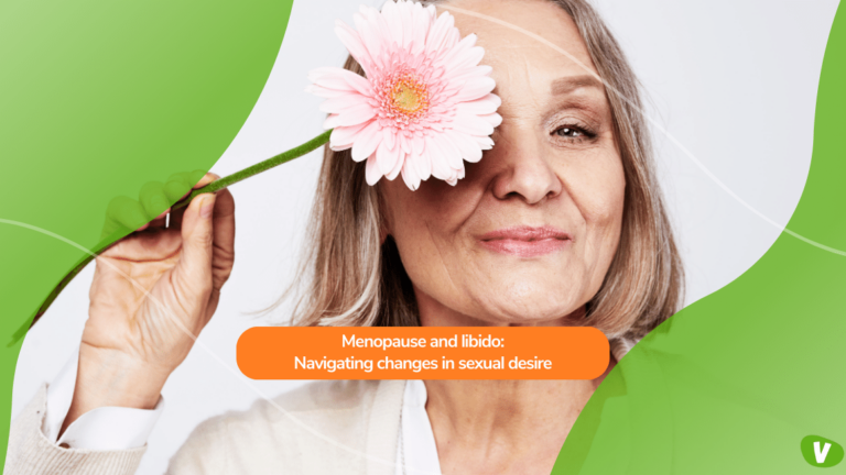 close up of an elderly woman holding a flower to her eye