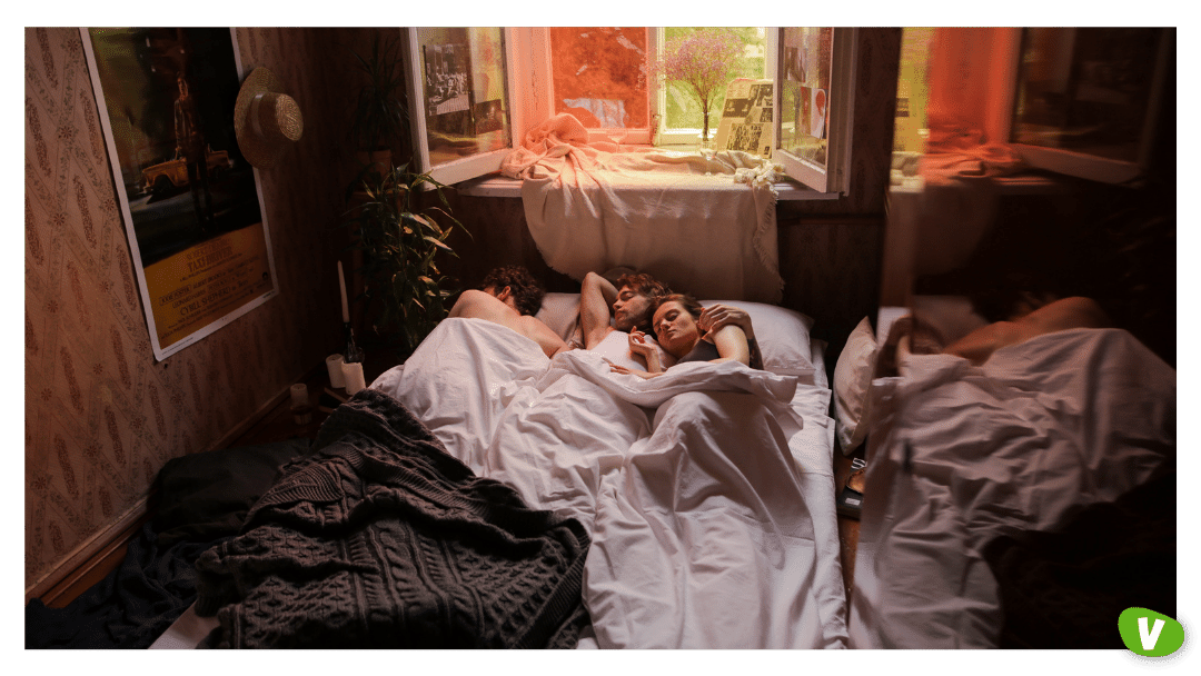 three young people laying in bed after a threesome