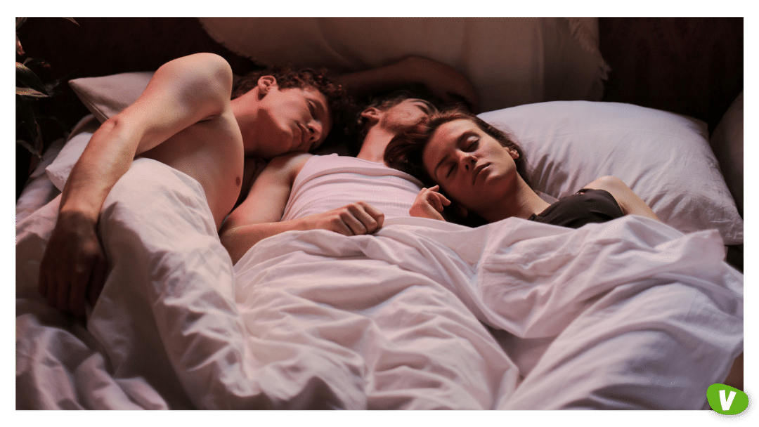 three young people laying in bed after a threesome