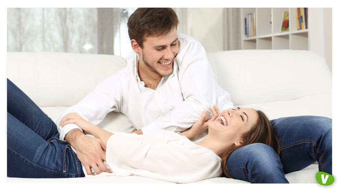 couple tickling each other on the sofa