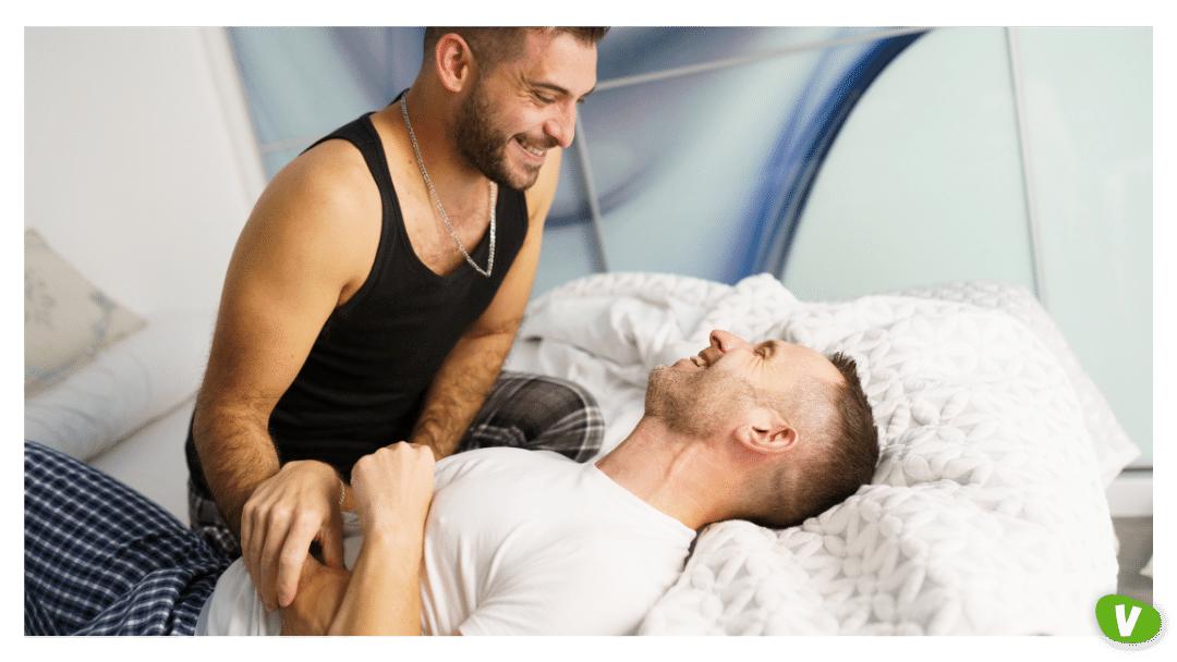gay couple tickling each other in bed