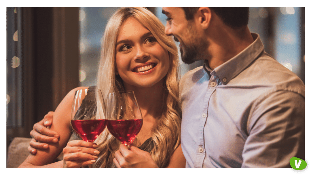 couple in a restaurant drinking wine and lovingly looking at each other