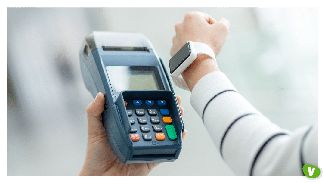 woman using a smartwatch to pay