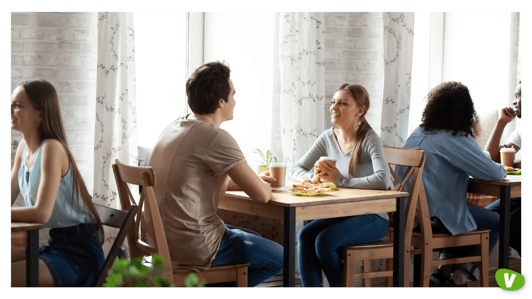 Diverse people sitting in cafe, participating in speed dating⁠