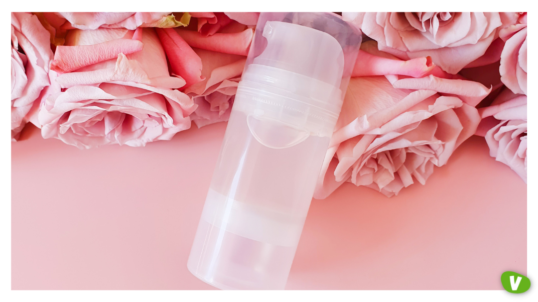 A sleek dispenser bottle placed on pink roses, representing the packaging and sensual appeal of orgasm gels marketed for heightened pleasure.