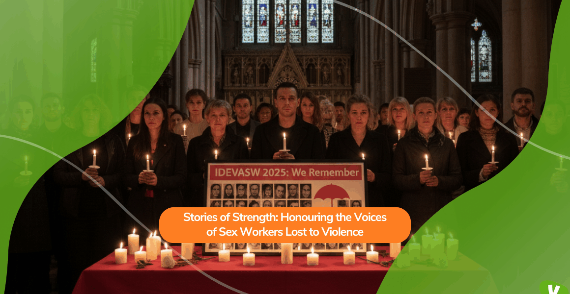 Inside a church, a group of people stands together holding candles in a vigil. A banner reading “IDEVASW 2025: We Remember” and photos of victims are displayed on a table surrounded by lit candles. The scene honours the memory of sex workers who have lost their lives to violence.
