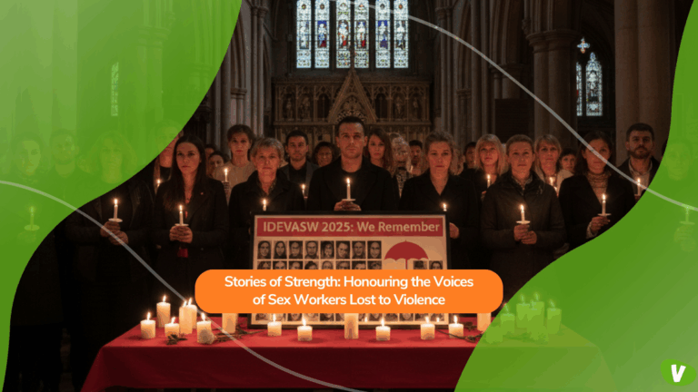 Inside a church, a group of people stands together holding candles in a vigil. A banner reading “IDEVASW 2025: We Remember” and photos of victims are displayed on a table surrounded by lit candles. The scene honours the memory of sex workers who have lost their lives to violence.