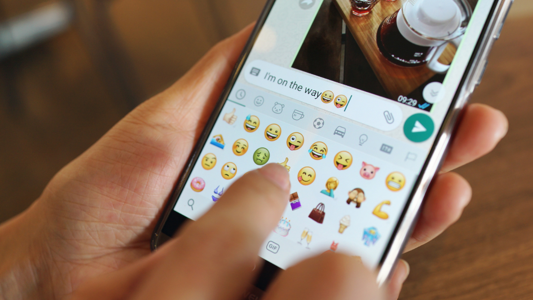 Woman sexting in phone using emojis